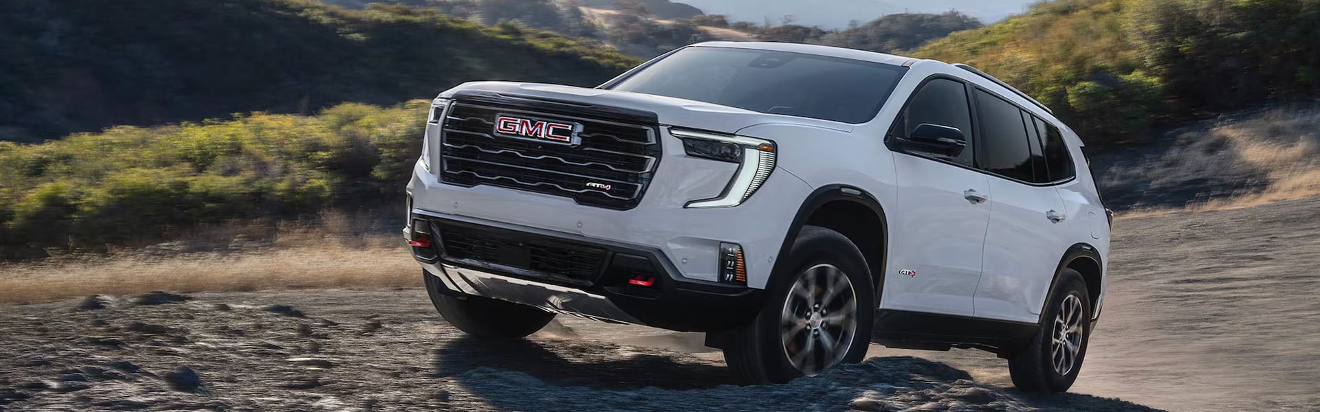 GMC Acadia models with scenic background